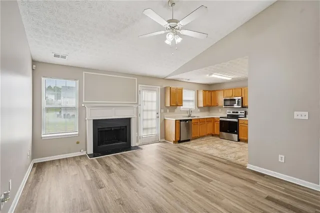 a view of a kitchen with a sink and a fireplace