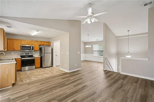 a view of a kitchen with wooden floor and a kitchen