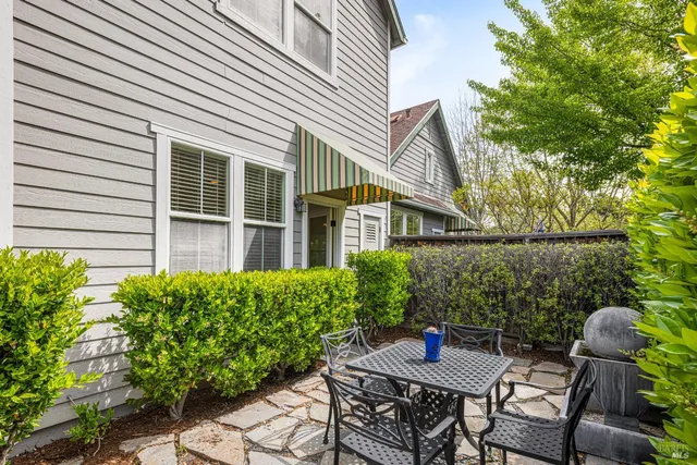 a living room with furniture kitchen view and a large window