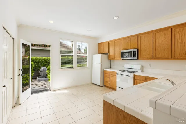 a kitchen with a sink a stove and cabinets