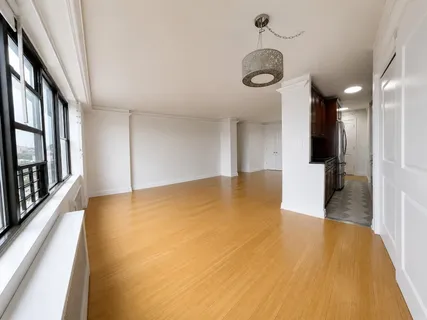 an empty room with windows and closet