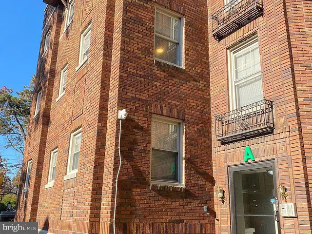 a view of a brick building with many windows
