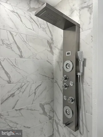 a bathroom with a shower and a mirror