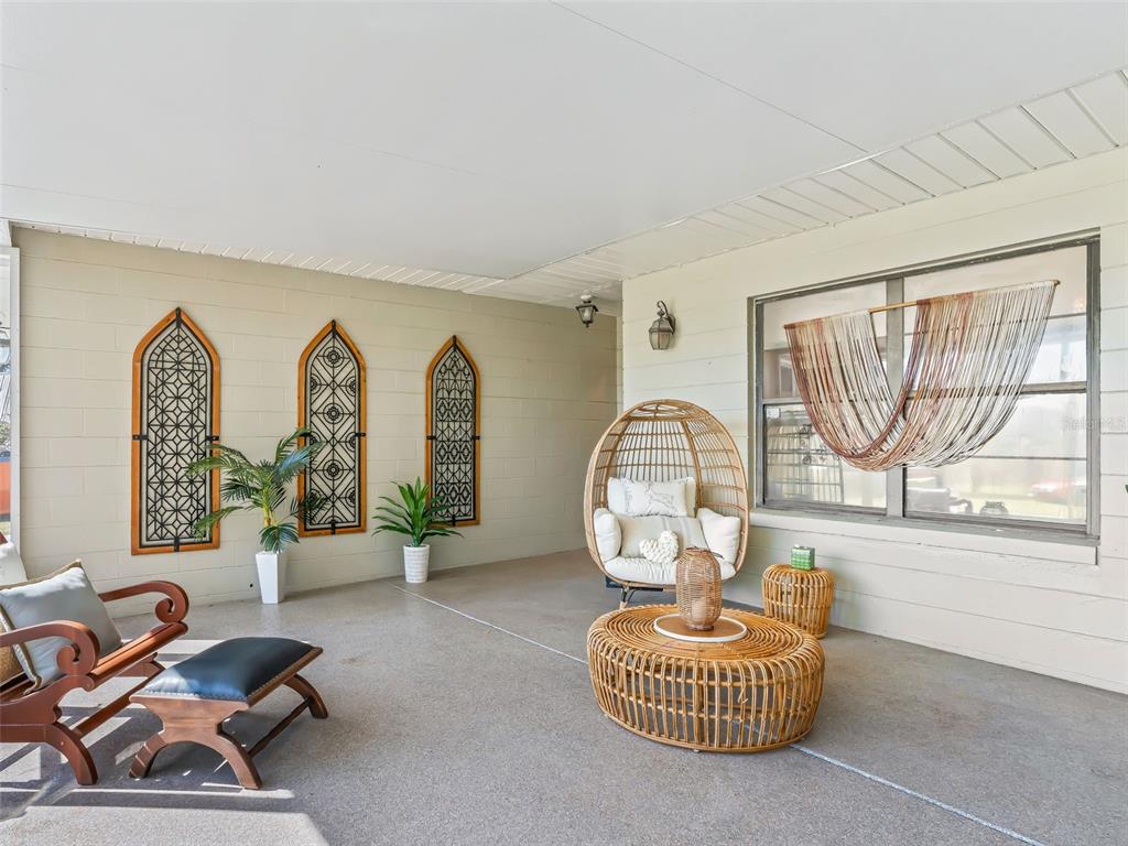 6350 Northeast 86th Avenue Bronson, FL 32621 - Photo 12 of 92 a living room with furniture a window and a chandelier