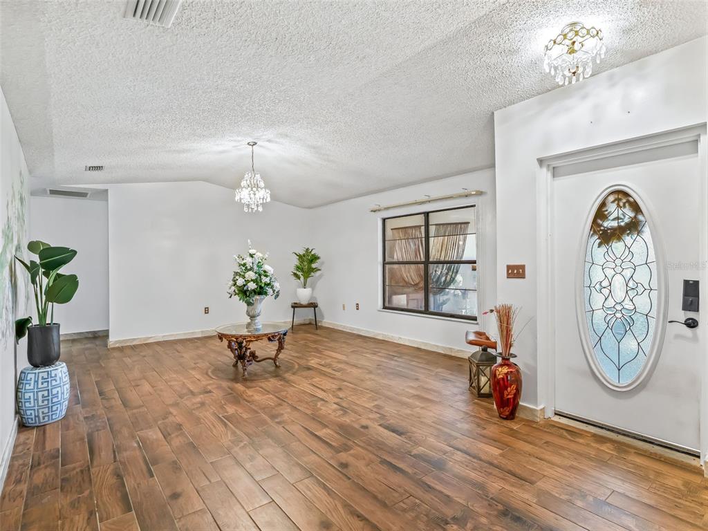 6350 Northeast 86th Avenue Bronson, FL 32621 - Photo 14 of 92 a view of living room filled with furniture and a chandelier