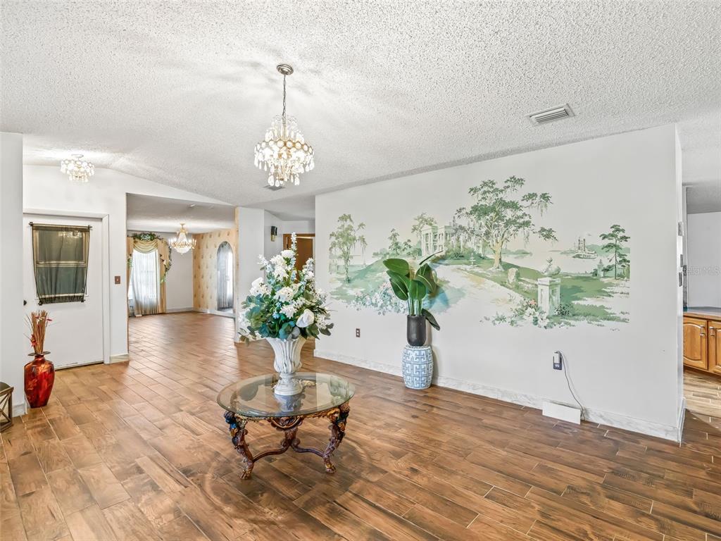 6350 Northeast 86th Avenue Bronson, FL 32621 - Photo 15 of 92 a living room with furniture and a chandelier