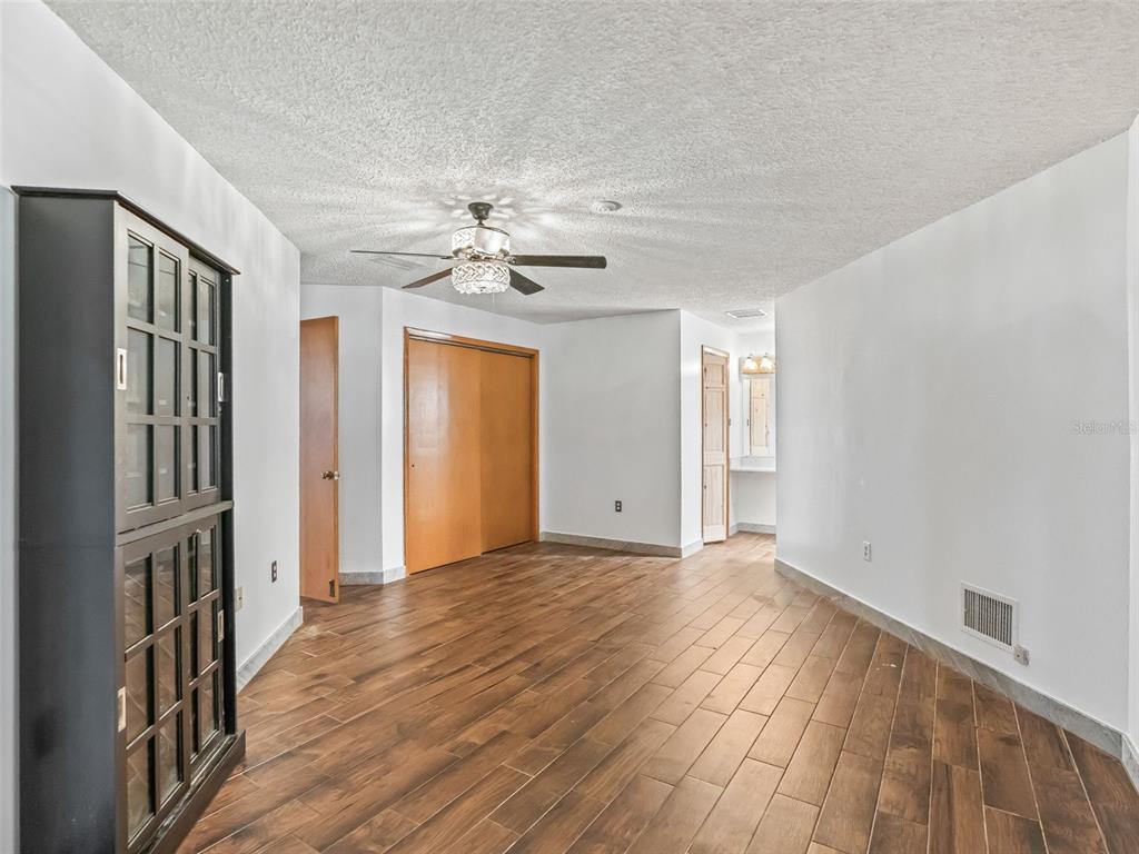 6350 Northeast 86th Avenue Bronson, FL 32621 - Photo 29 of 92 a view of an empty room with wooden floor and a window