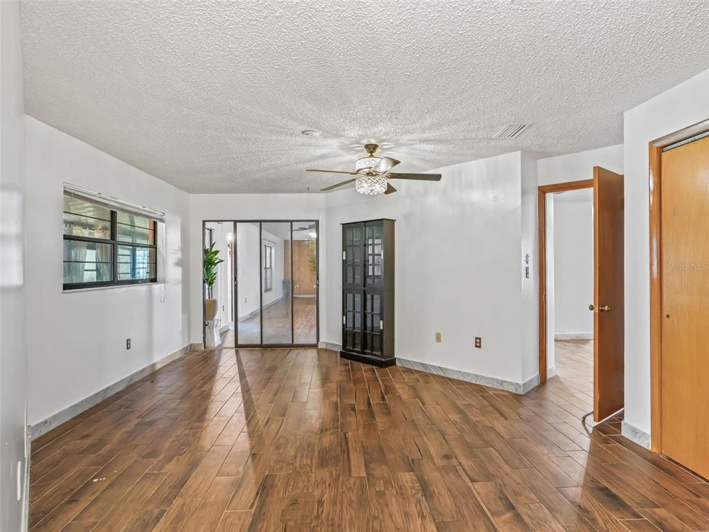 6350 Northeast 86th Avenue Bronson, FL 32621 - Photo 30 of 92 wooden floor in an empty room with a window