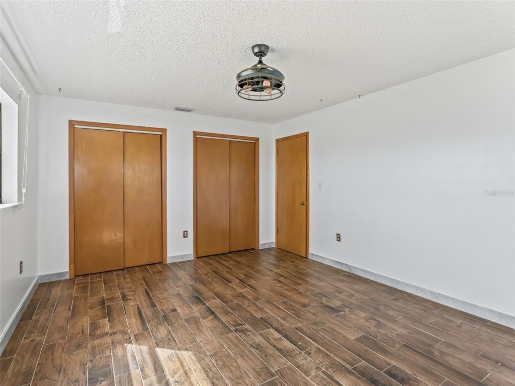 6350 Northeast 86th Avenue Bronson, FL 32621 - Photo 39 of 92 a view of empty room with wooden floor