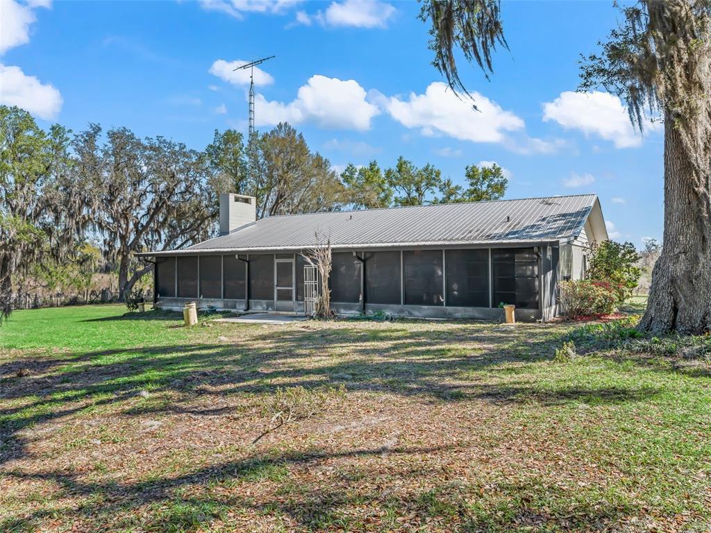 6350 Northeast 86th Avenue Bronson, FL 32621 - Photo 45 of 92 a front view of a house with a yard