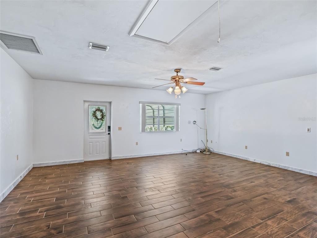 6350 Northeast 86th Avenue Bronson, FL 32621 - Photo 53 of 92 an empty room with wooden floor and windows
