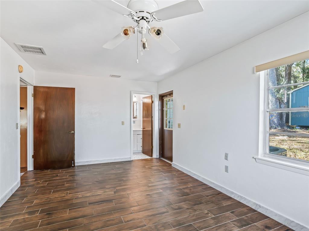 6350 Northeast 86th Avenue Bronson, FL 32621 - Photo 59 of 92 a view of an empty room with wooden floor and a window