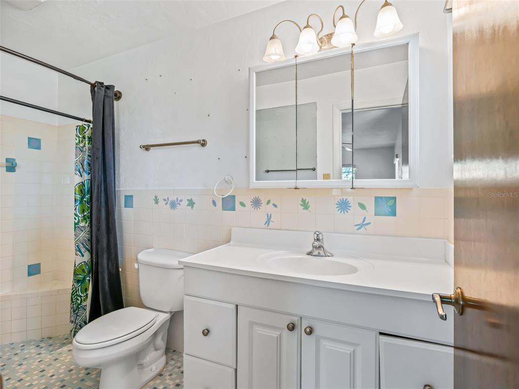 6350 Northeast 86th Avenue Bronson, FL 32621 - Photo 60 of 92 a bathroom with a sink a toilet and a mirror