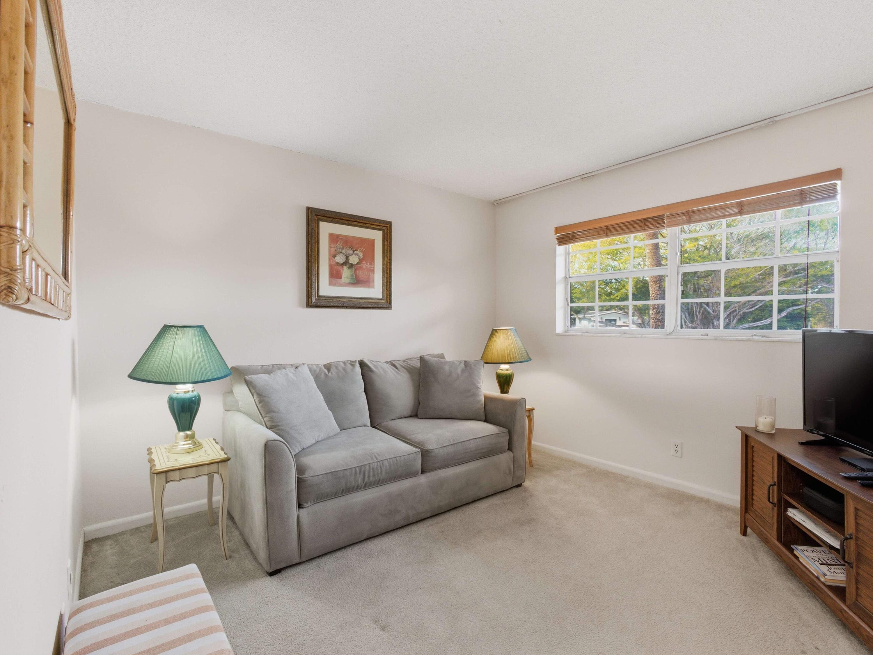 400 Northeast 20th Street, Unit A216 Boca Raton, FL 33431 - Photo 20 of 33 a living room with furniture and a flat screen tv