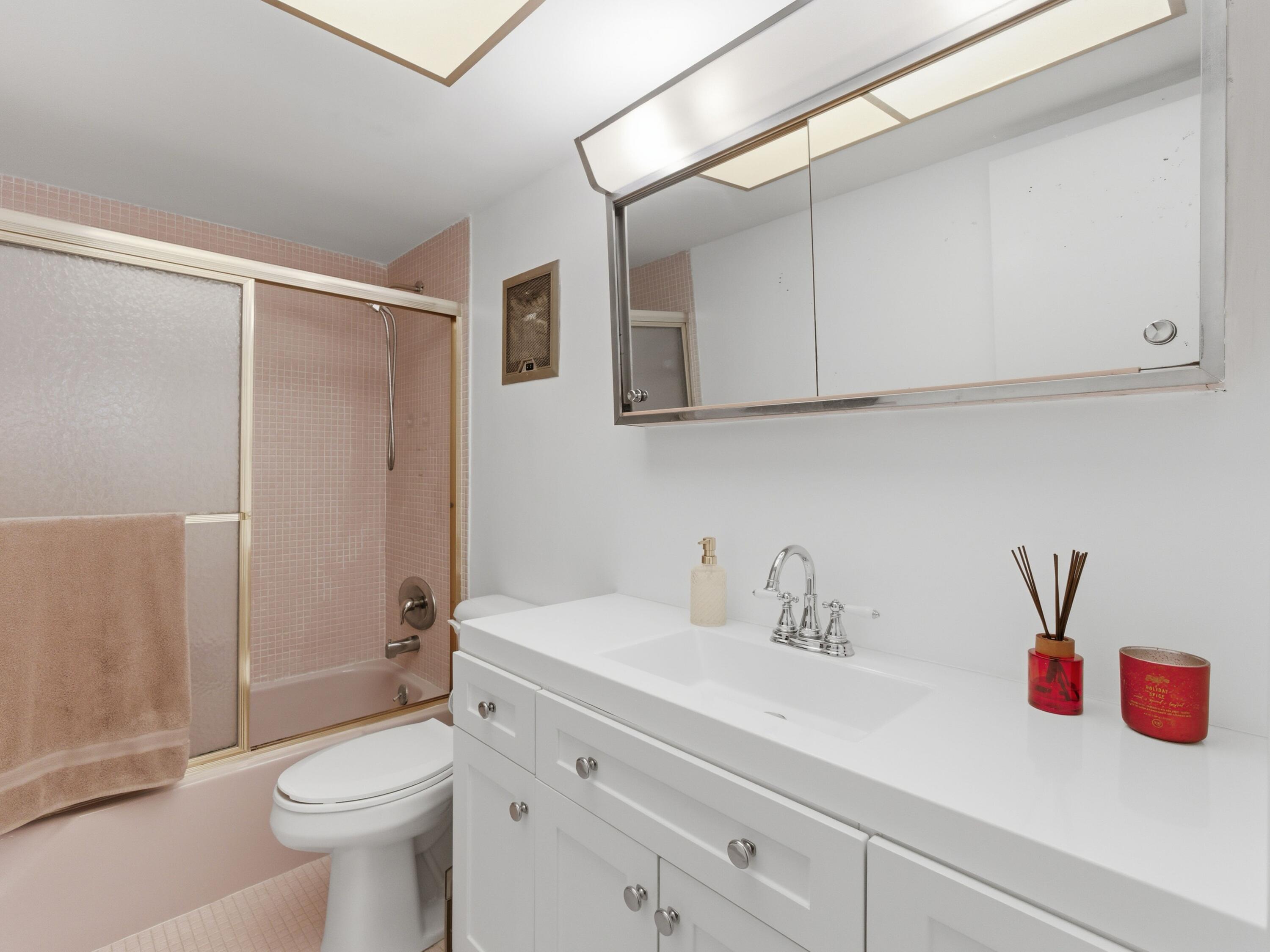 400 Northeast 20th Street, Unit A216 Boca Raton, FL 33431 - Photo 24 of 33 a bathroom with a sink a toilet and shower