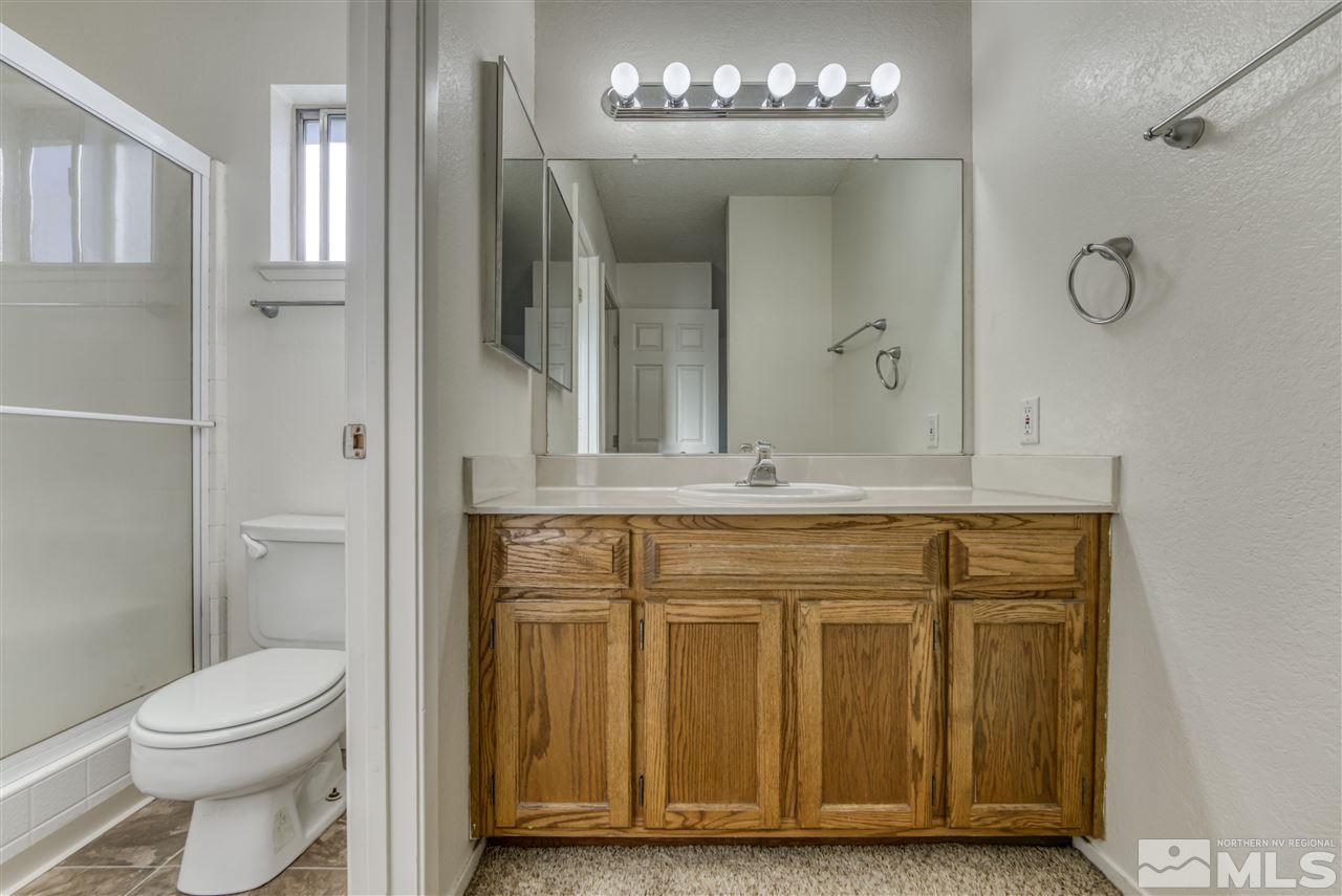 2741 Pajaro Place Reno, NV 89502 - Photo 30 of 36 a bathroom with a sink a toilet and mirror