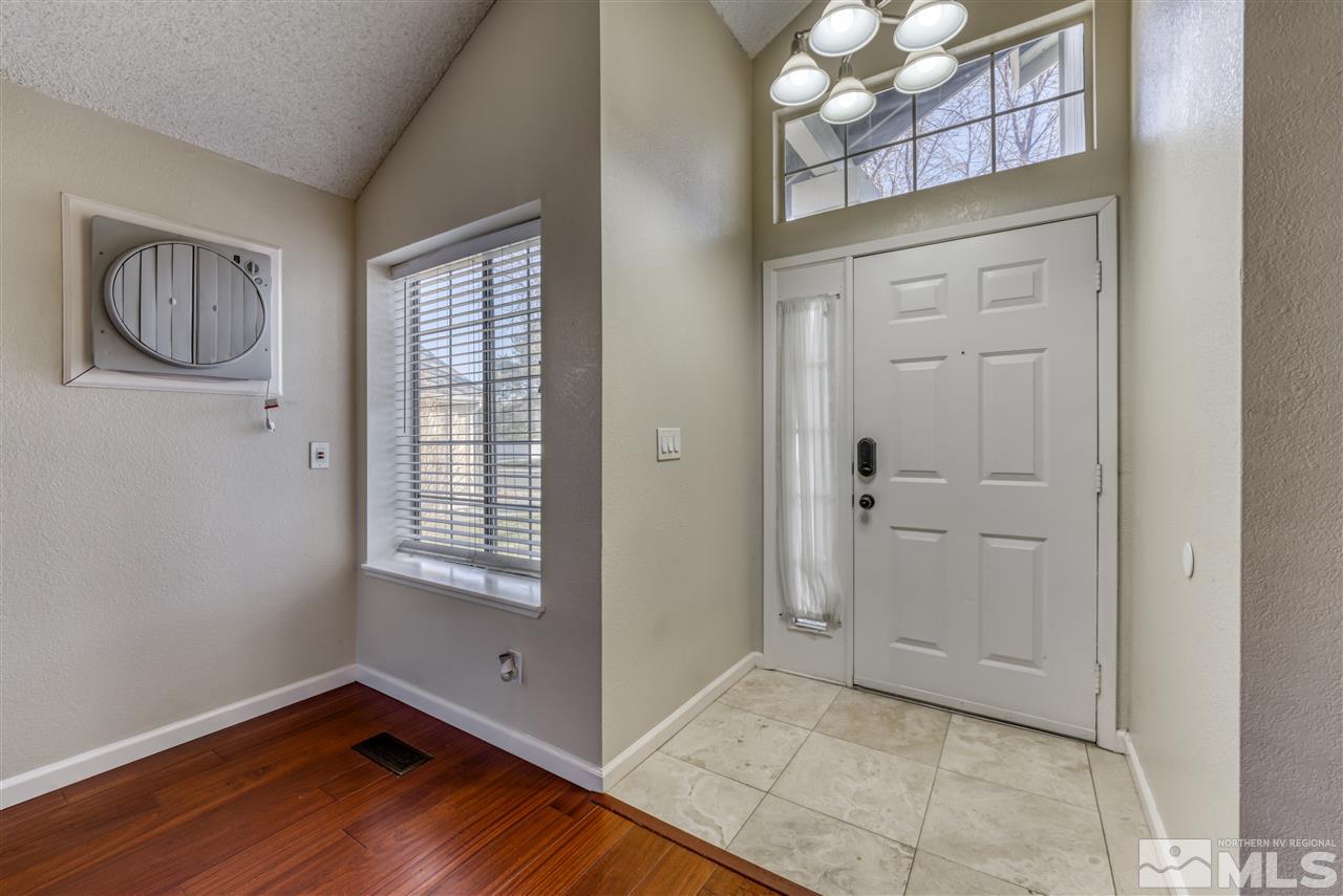 2741 Pajaro Place Reno, NV 89502 - Photo 4 of 36 a view of an empty room with wooden floor and a window