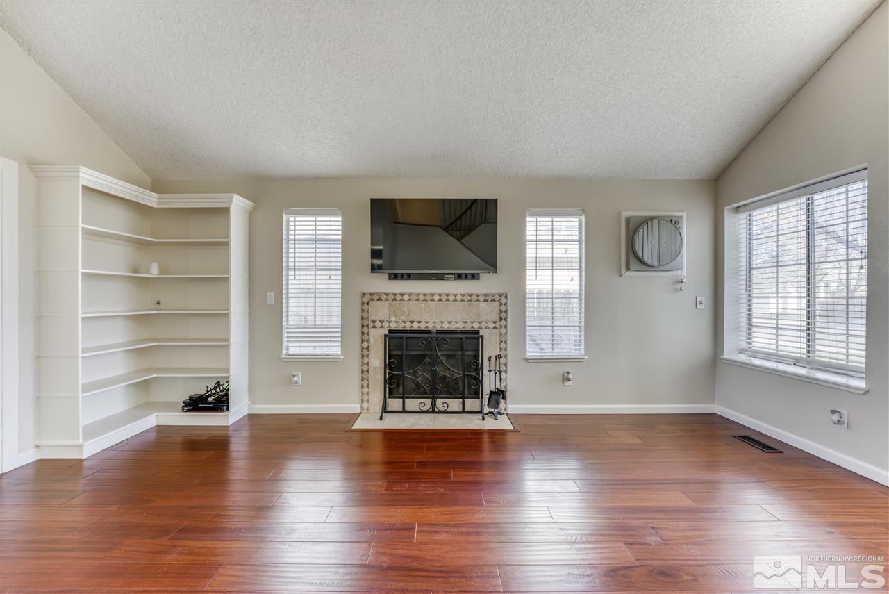 2741 Pajaro Place Reno, NV 89502 - Photo 7 of 36 a living room with hard wood floors and a fireplace
