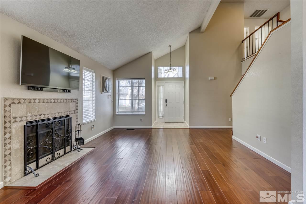 2741 Pajaro Place Reno, NV 89502 - Photo 9 of 36 wooden floor fireplace and windows in an empty room