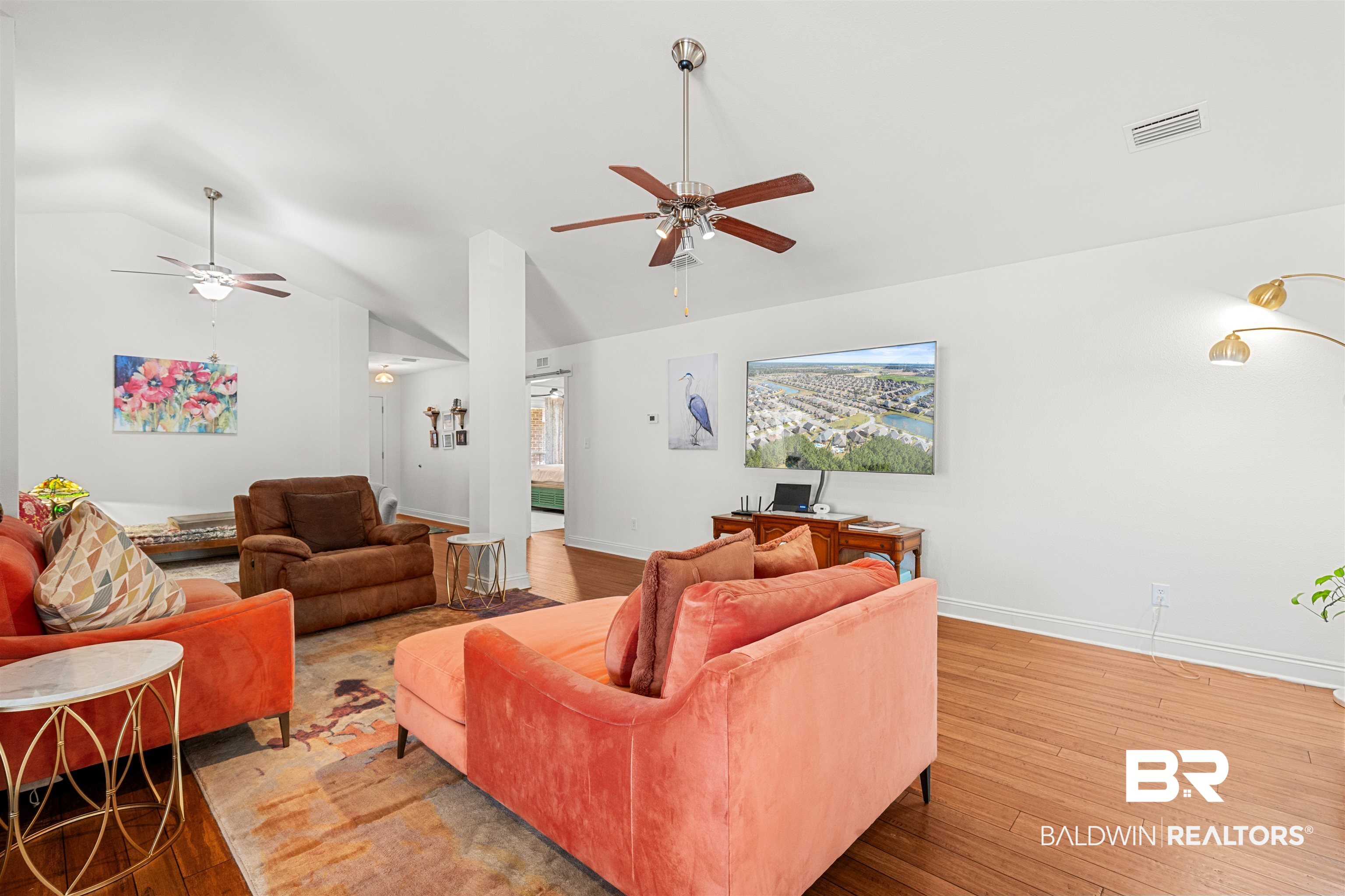 1850 Arcadia Drive Foley, AL 36535 - Photo 10 of 44 Living room featuring ceiling fan, visible vents, vaulted ceiling, and wood finished floors
