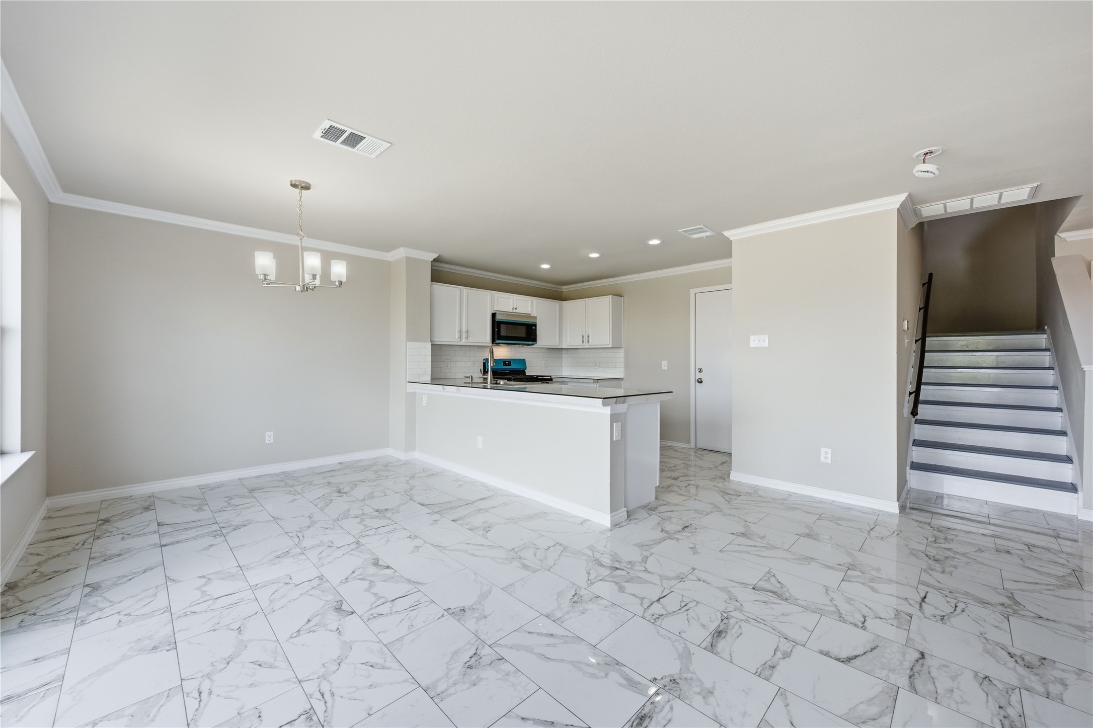 6917 Panda Royle Drive Del Valle, TX 78617 - Photo 7 of 23 An open concept living area transitions effortlessly into a contemporary kitchen, creating a seamless flow.