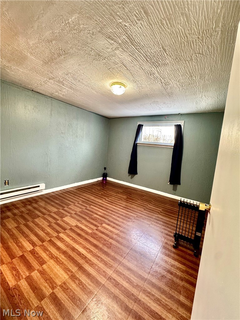 2852 Shelly Road Ravenna, OH 44266 - Photo 6 of 30 Unfurnished room with baseboards and a baseboard heating unit