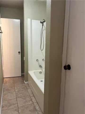 a bathroom with a bath tub and shower