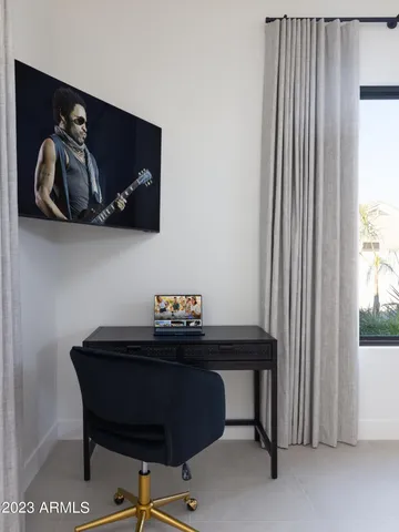 a bedroom with a bed and a large window