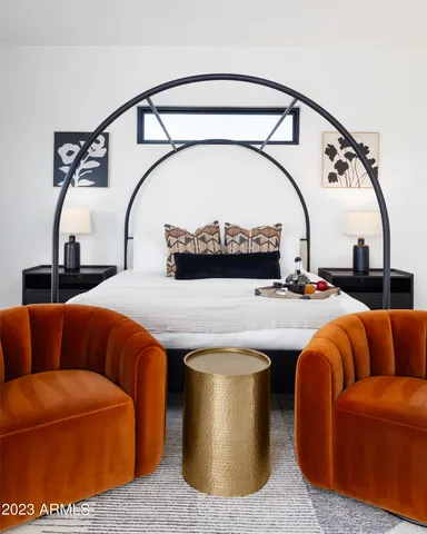 a en suite bathroom with a double vanity sink a mirror and a bathtub