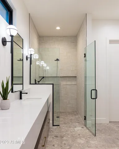 a bedroom with a bed and a large window