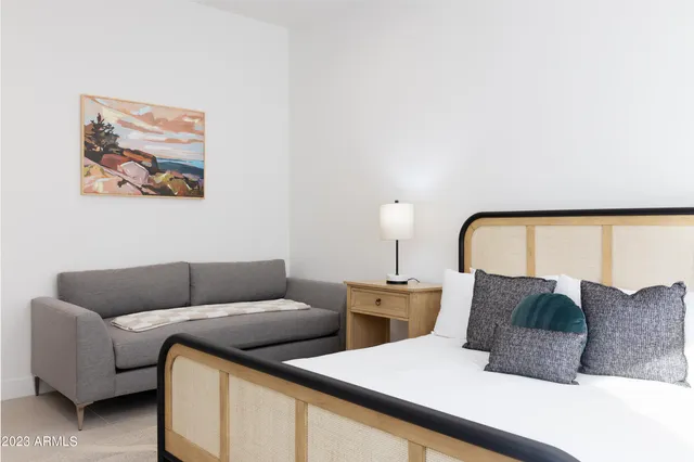 a bedroom with a bed and a night stand