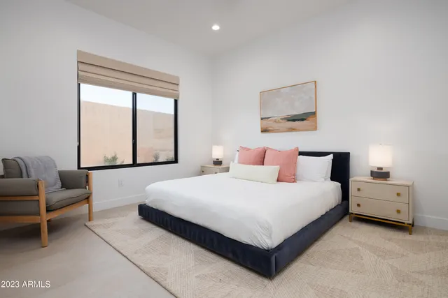 a bedroom with a bed and a lamp