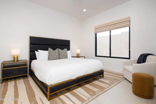 a living room with furniture and large windows