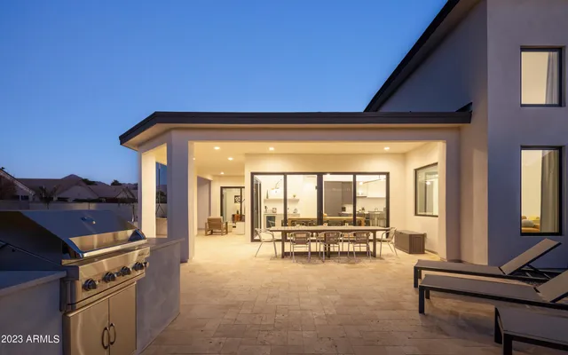 a view of a house with a yard patio and a fire pit