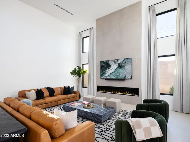 a living room with furniture and a potted plant