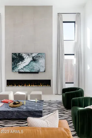 a living room with furniture gym equipment and a chandelier