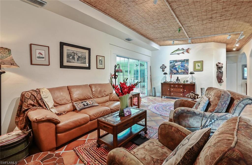 3113 Basin Street Naples, FL 34112 - Photo 13 of 49 a living room with furniture and a chandelier