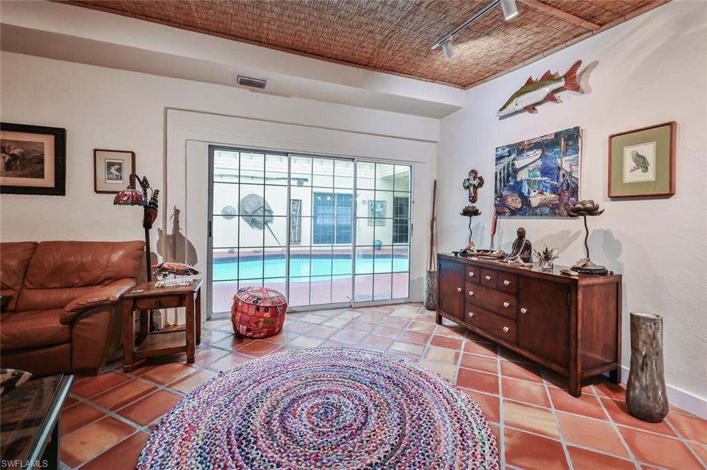 3113 Basin Street Naples, FL 34112 - Photo 14 of 49 a bedroom with furniture and large windows