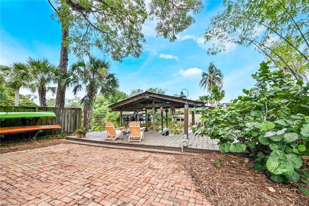 3113 Basin Street Naples, FL 34112 - Photo 2 of 49 a view of a park with plants and a bench