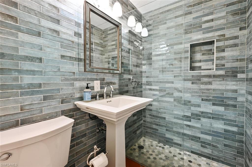 3113 Basin Street Naples, FL 34112 - Photo 27 of 49 a bathroom with a sink a toilet and mirror