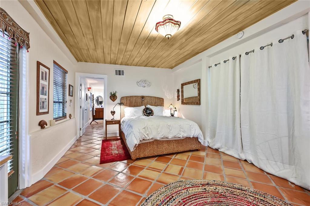3113 Basin Street Naples, FL 34112 - Photo 29 of 49 a spacious bedroom with a bed and a window