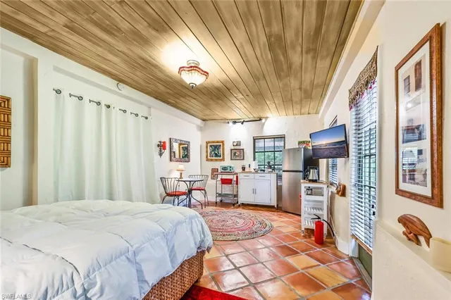 a bed room with a bed and a chair