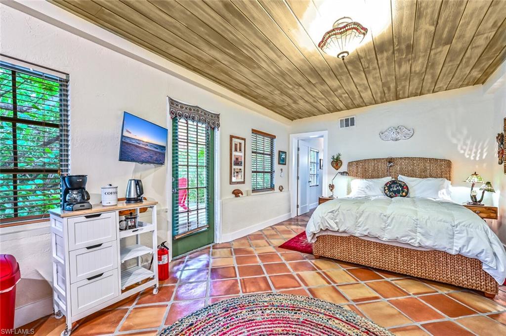 3113 Basin Street Naples, FL 34112 - Photo 31 of 49 a bedroom with a bed and a book shelf