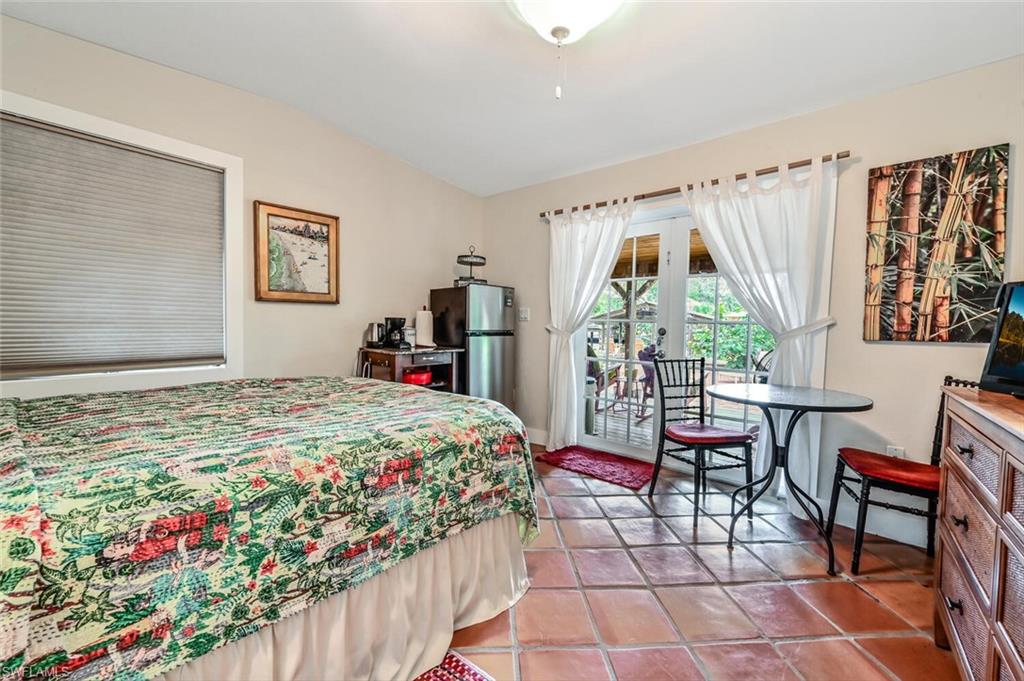 3113 Basin Street Naples, FL 34112 - Photo 35 of 49 a bedroom with a bed and a window