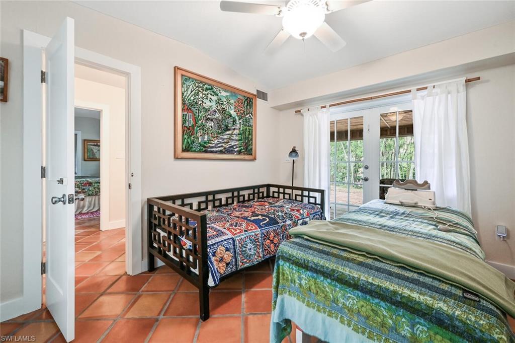 3113 Basin Street Naples, FL 34112 - Photo 37 of 49 a bed sitting in a bedroom next to a window