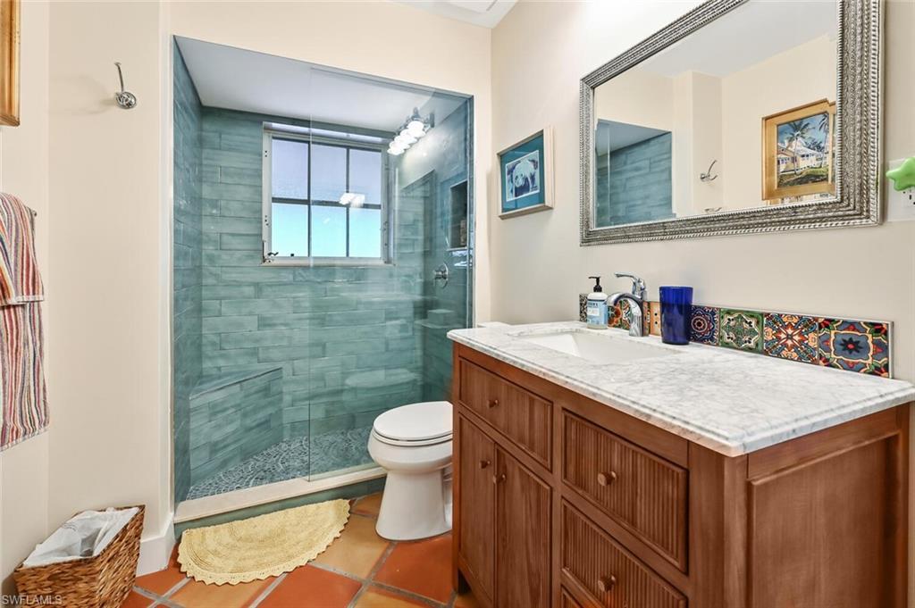 3113 Basin Street Naples, FL 34112 - Photo 38 of 49 a bathroom with a sink a toilet and shower