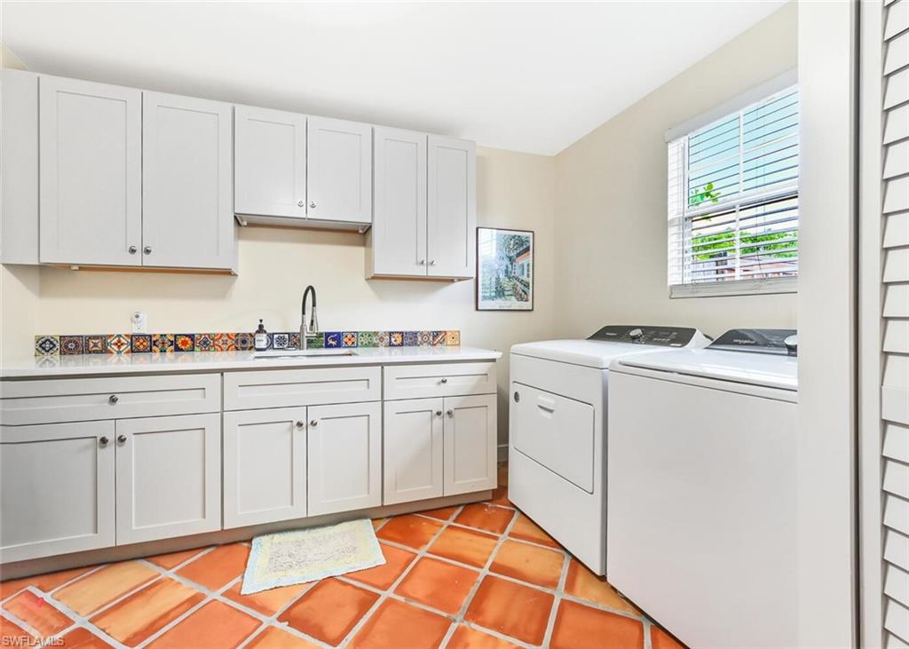 3113 Basin Street Naples, FL 34112 - Photo 39 of 49 a kitchen with granite countertop white cabinets and white appliances