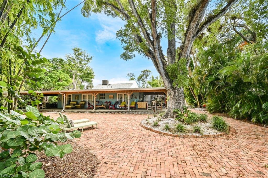 3113 Basin Street Naples, FL 34112 - Photo 4 of 49 a front view of a house with a yard
