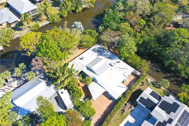 an aerial view of a house with a yard and garden