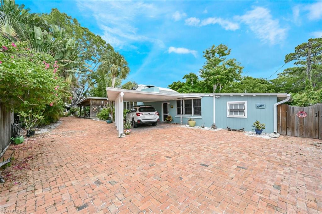 3113 Basin Street Naples, FL 34112 - Photo 10 of 49 a house with trees in the background